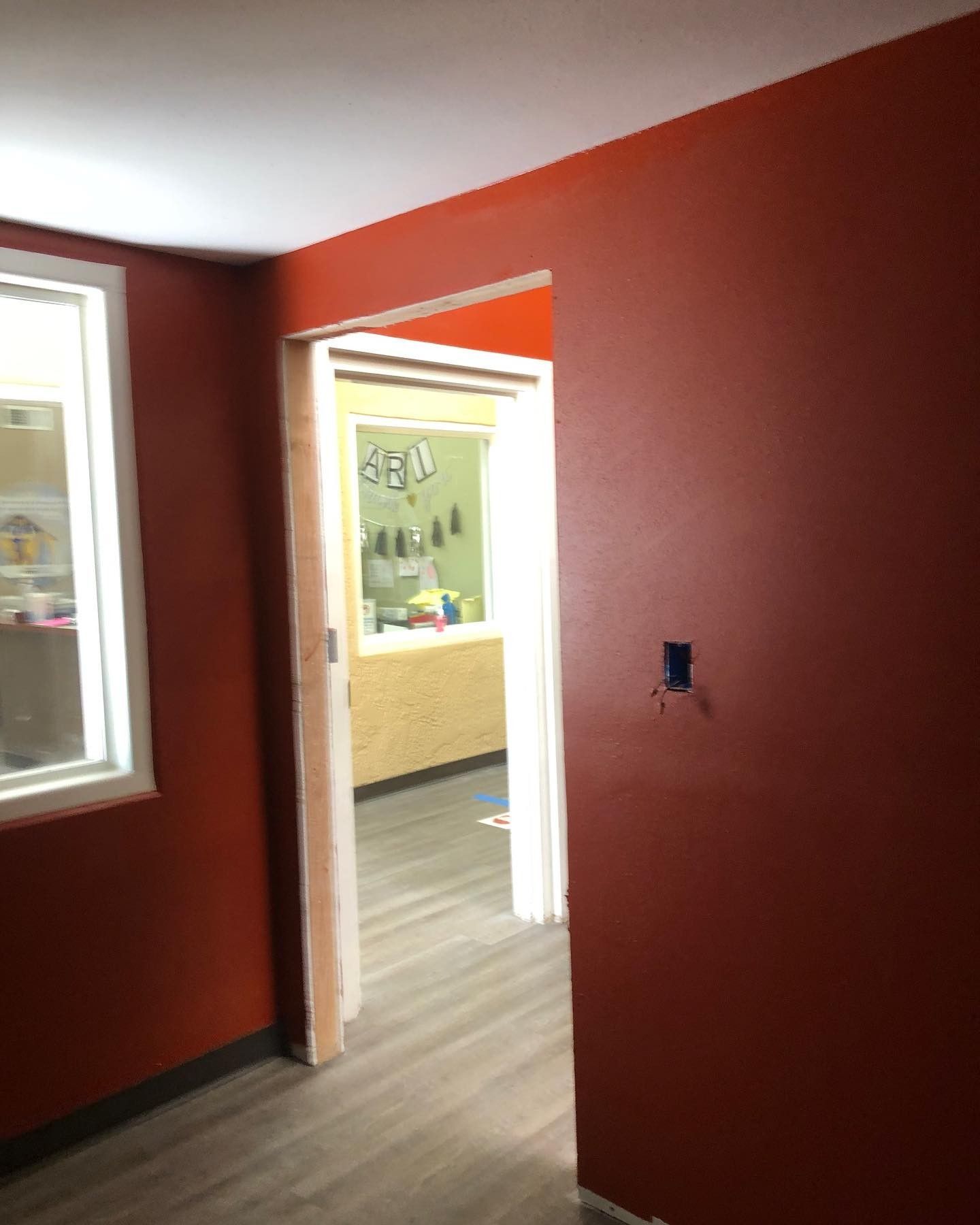 A room with red walls and a door that is open