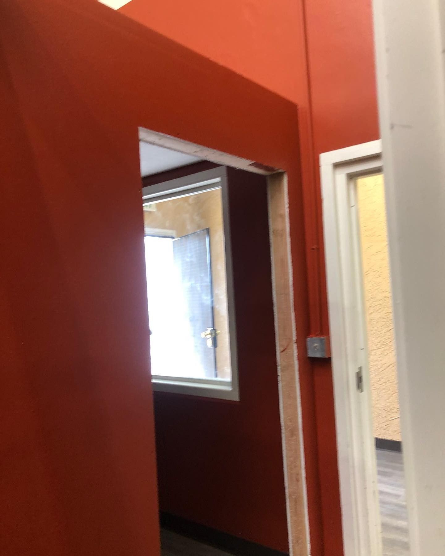 A room with red walls and a white door