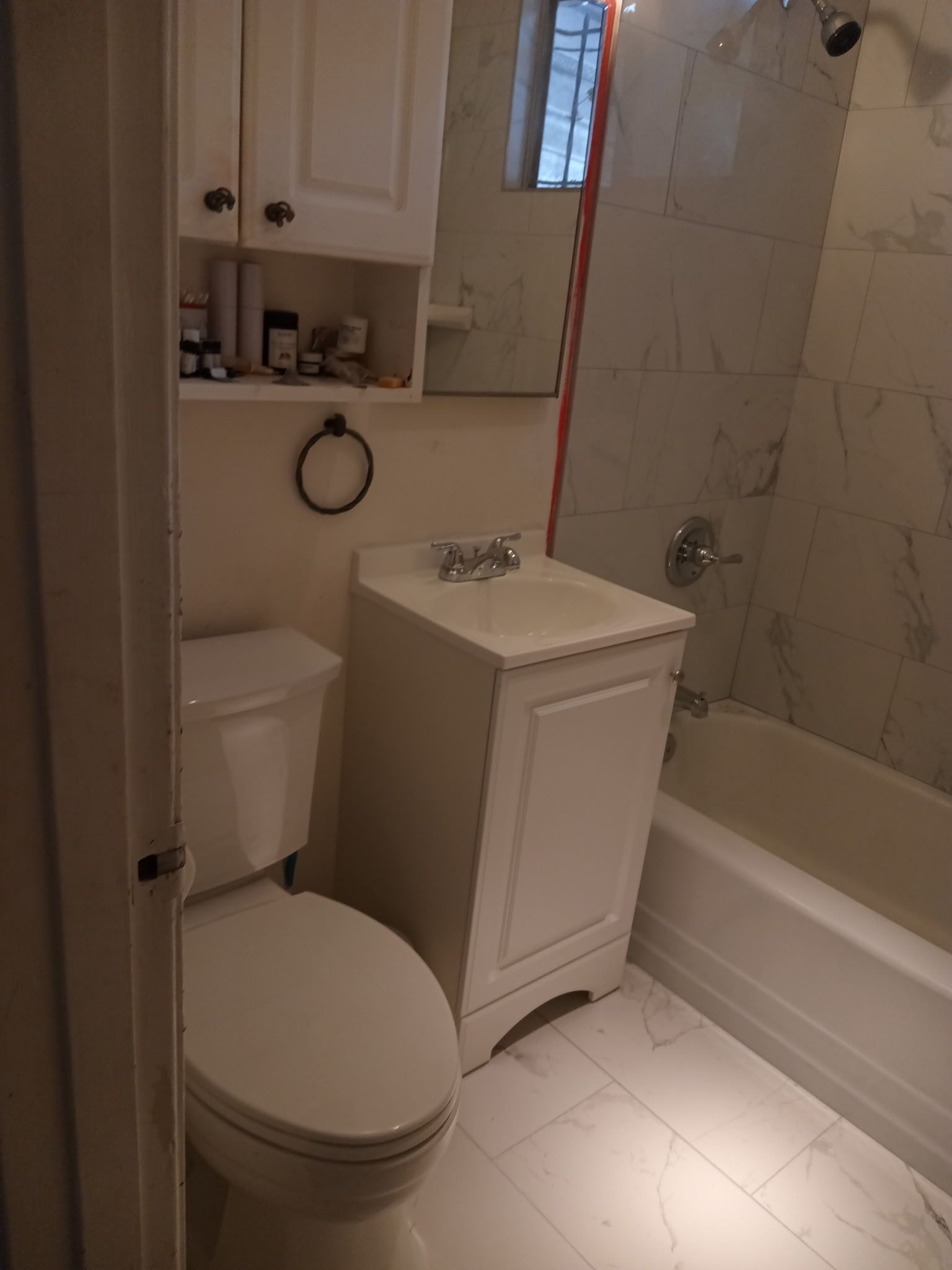 A white truck is parked in a parking lot next to a building.