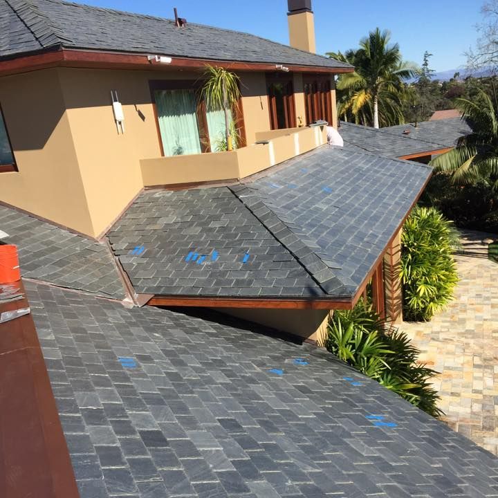 A large house with a roof that is covered in shingles