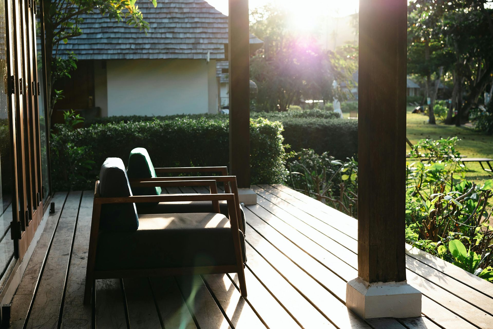 A wooden deck with two chairs on it