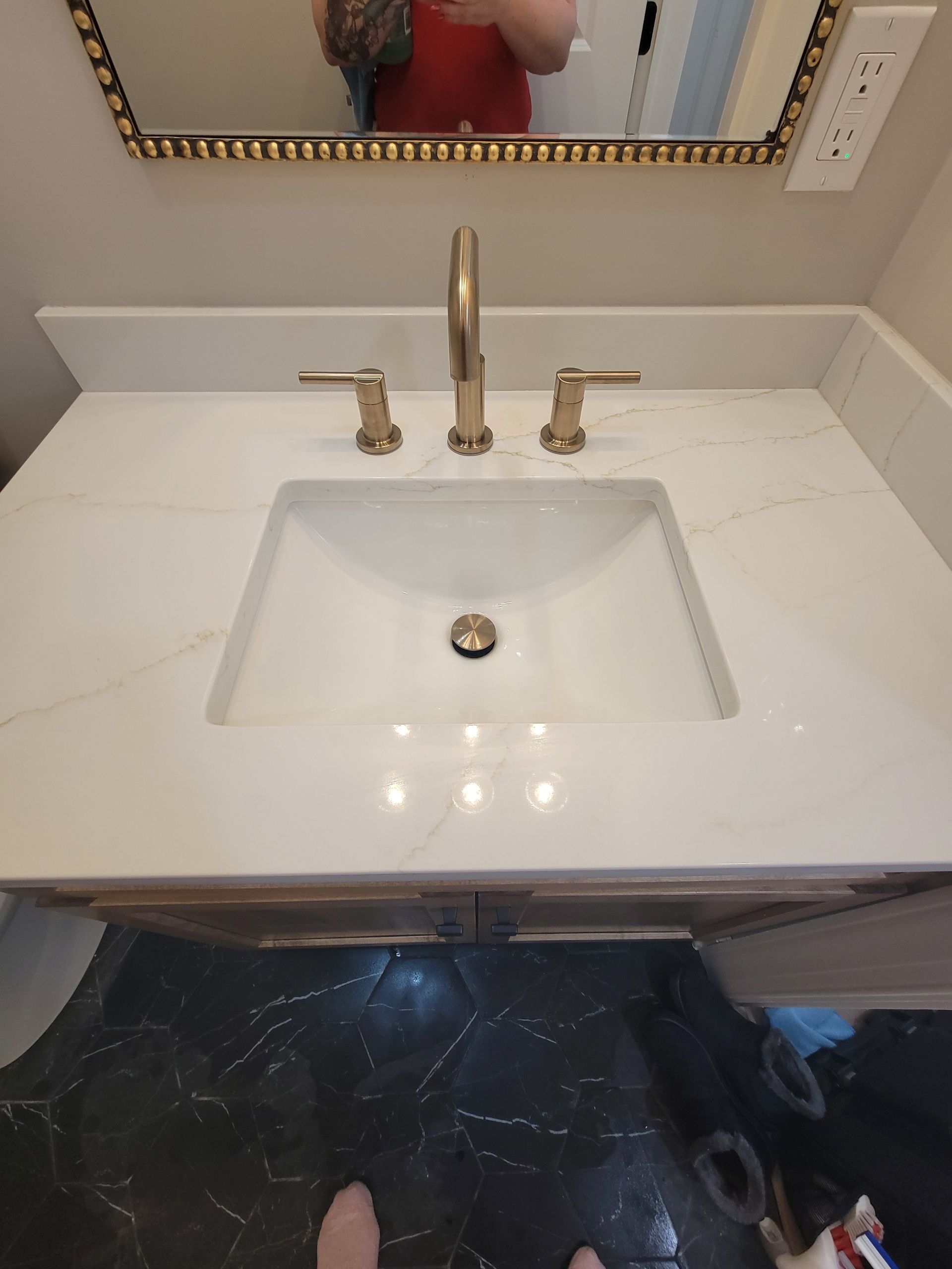 A bathroom sink with a faucet and a mirror.