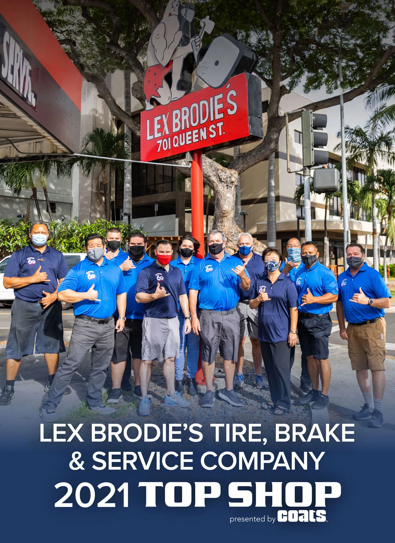 A group of people are posing for a picture in front of a lex brodie 's tire brake and service company sign. | Lex Brodies