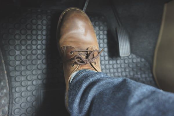 A person is pressing the brake pedal of a car. | Lex Brodies