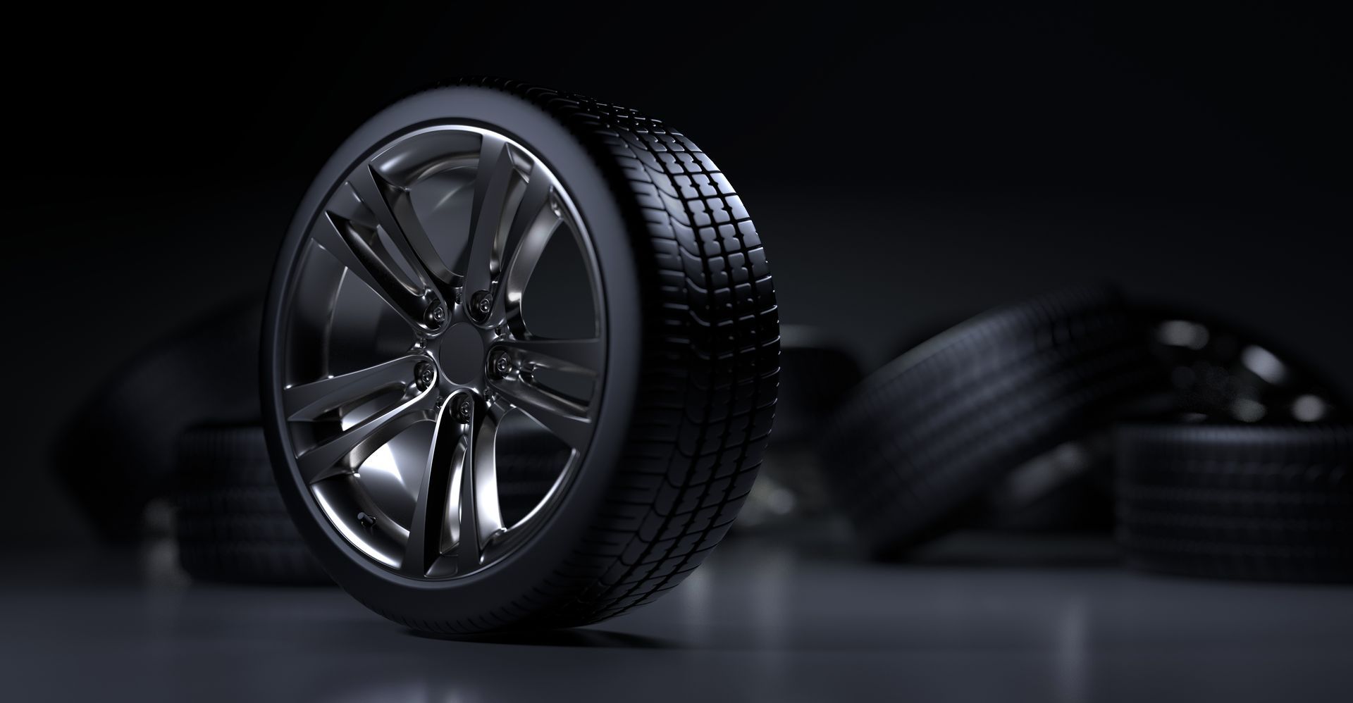 A close up of a car tire with a stack of tires in the background | Lex Brodies