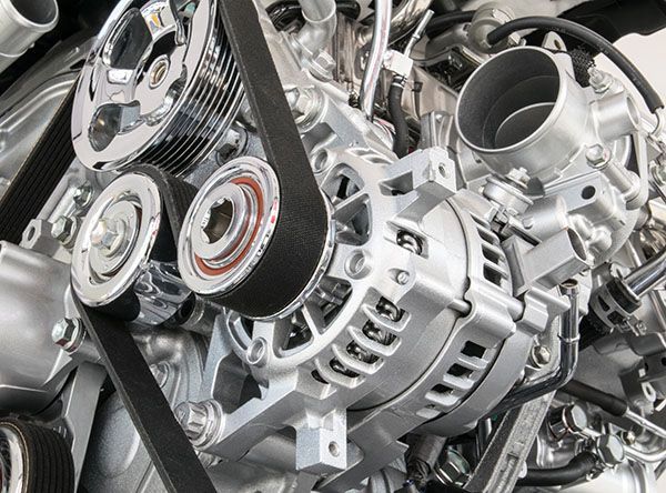 A close up of a car engine with a belt on it | Lex Brodies