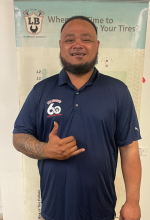 A man with a beard is wearing a blue shirt and giving a thumbs up. | Lex Brodies 