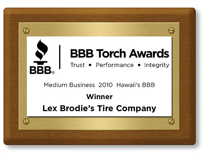 A plaque that says bbb torch awards medium business 2010 hawaii 's bbb winner lex brodie 's tire company | Lex Brodies