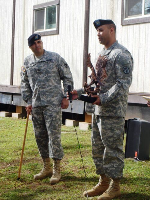 Two soldiers standing next to each other in front of a building | Lex Brodies