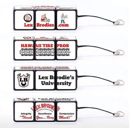 A set of four cube keychains with different logos on them. | Lex Brodies 