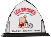 A plaque with a cartoon of a man kneeling down holding a rock. | Lex Brodies 