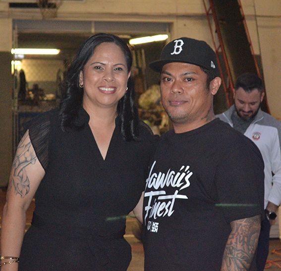 A man wearing a hawaii 's fried shirt poses with a woman | Lex Brodies