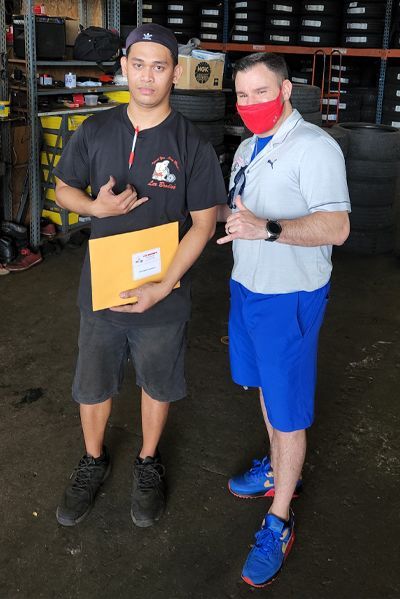 Two men wearing masks are standing next to each other in a garage | Lex Brodies