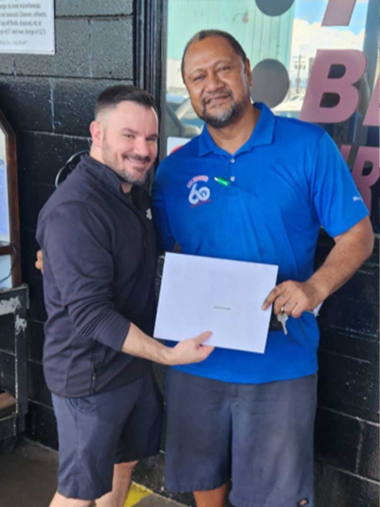 A man in a blue shirt is holding a piece of paper | Lex Brodies