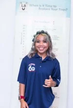 A woman in a blue polo shirt is smiling and giving a thumbs up. | Lex Brodies 