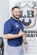 A man in a blue polo shirt is giving a thumbs up. | Lex Brodies