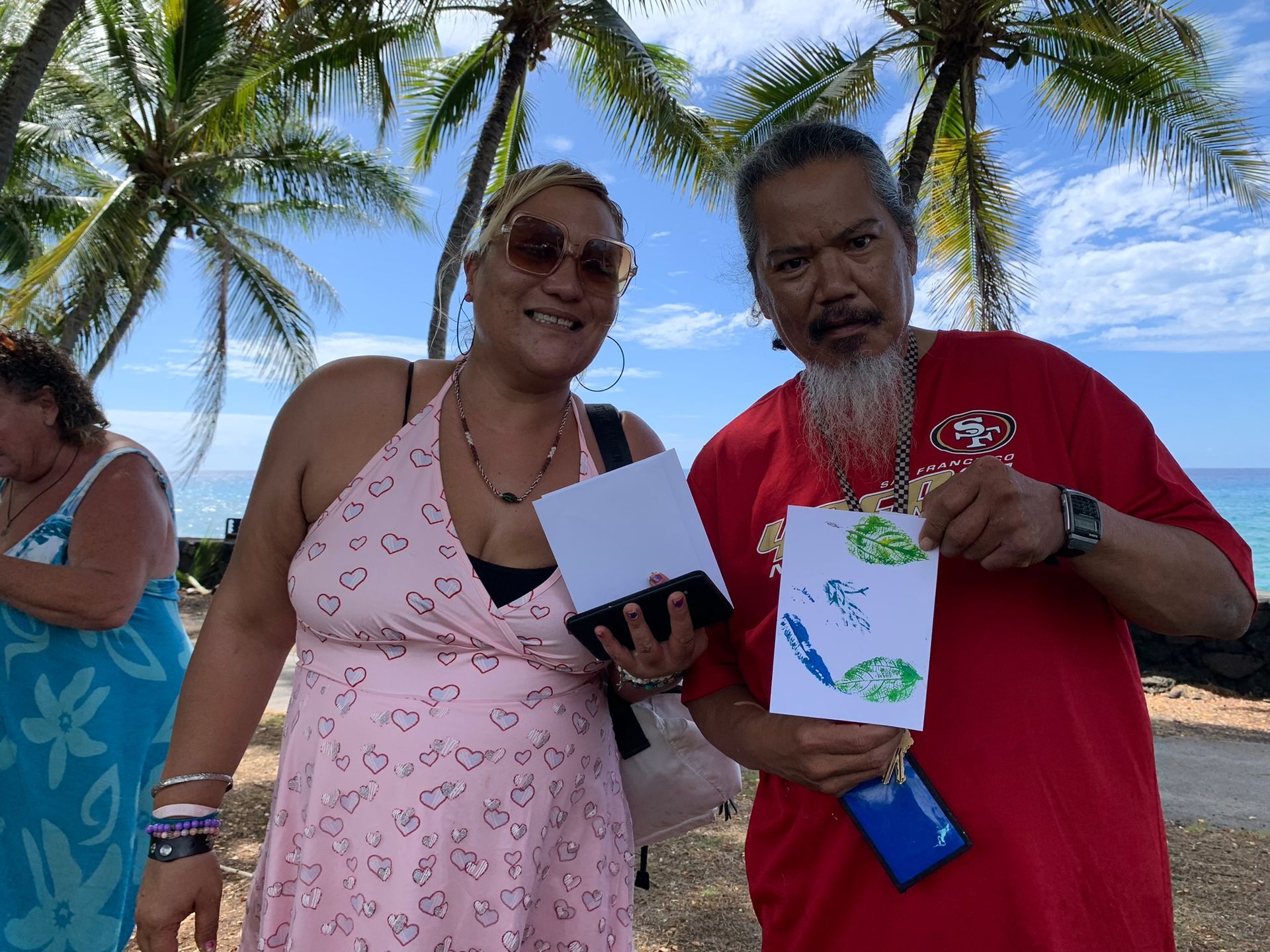 A group of people and a dog are standing in a field.