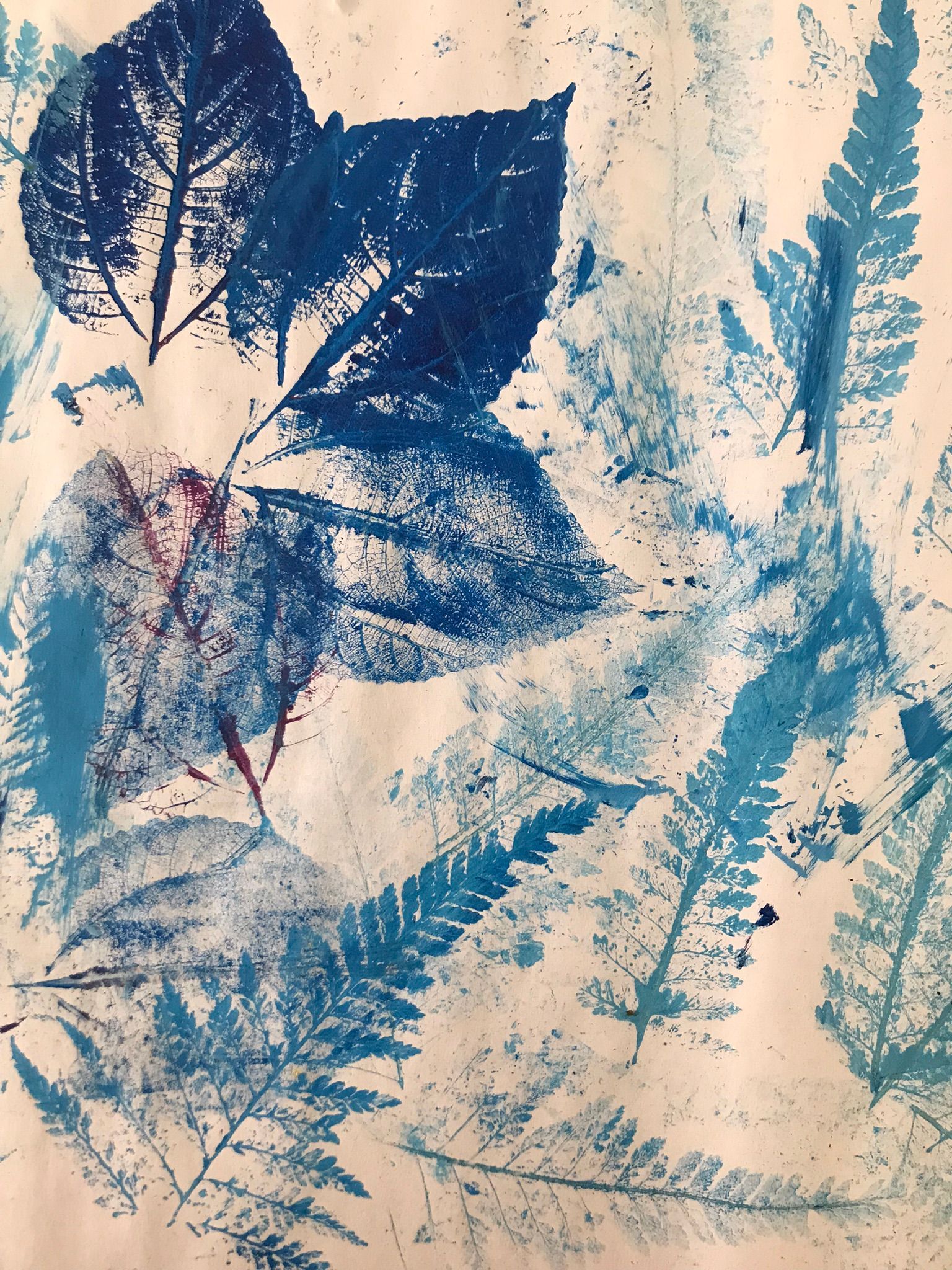 A group of men are standing around a painting on an easel in a park.