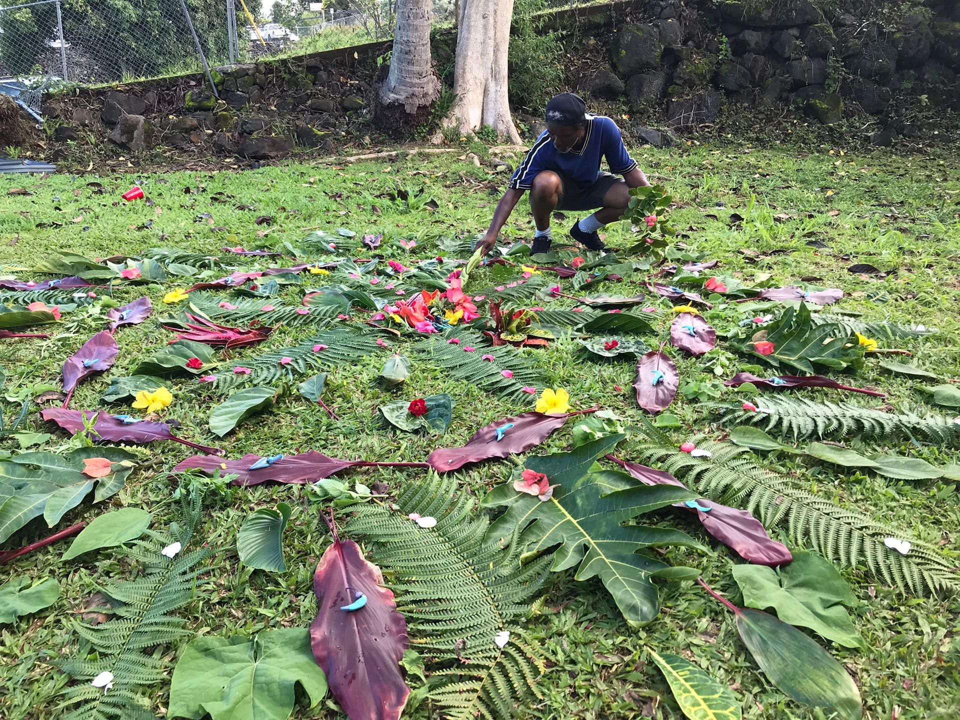 A group of people and a dog are standing in a field.