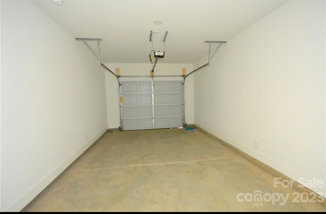 An empty garage with a canopy that is for sale