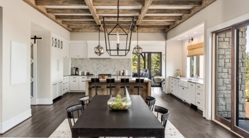 A kitchen and dining room in a house with a table and chairs.