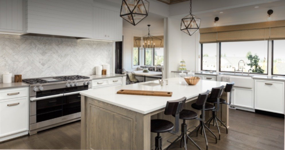 A kitchen with a large island in the middle of it.