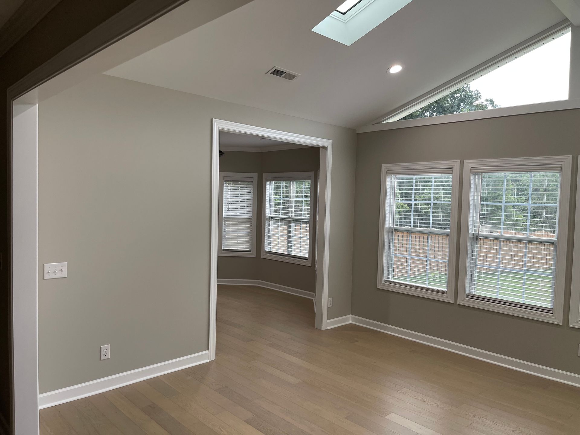 There is a skylight in the ceiling of the living room.