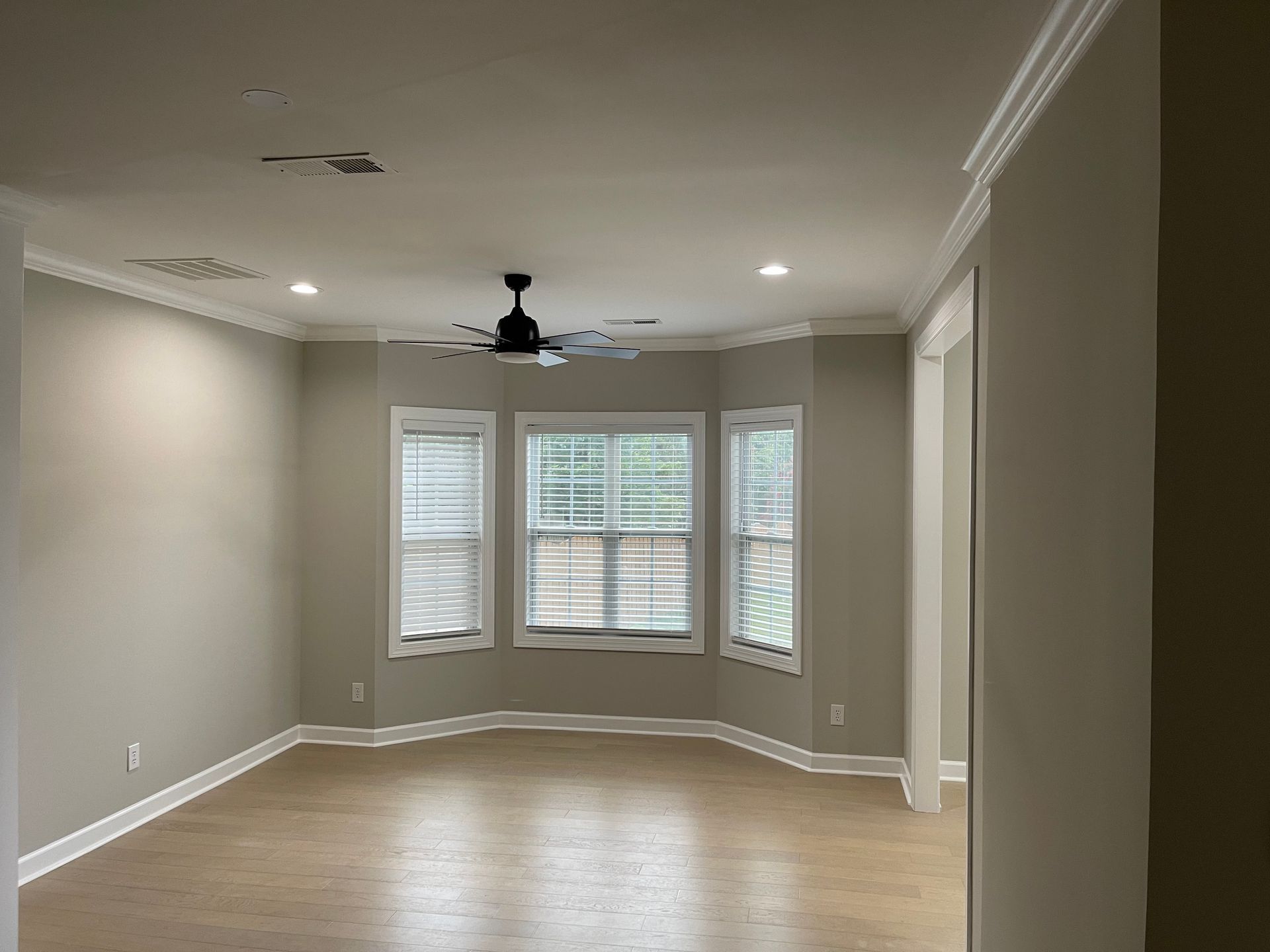 A room with a lot of windows and a skylight in the ceiling.