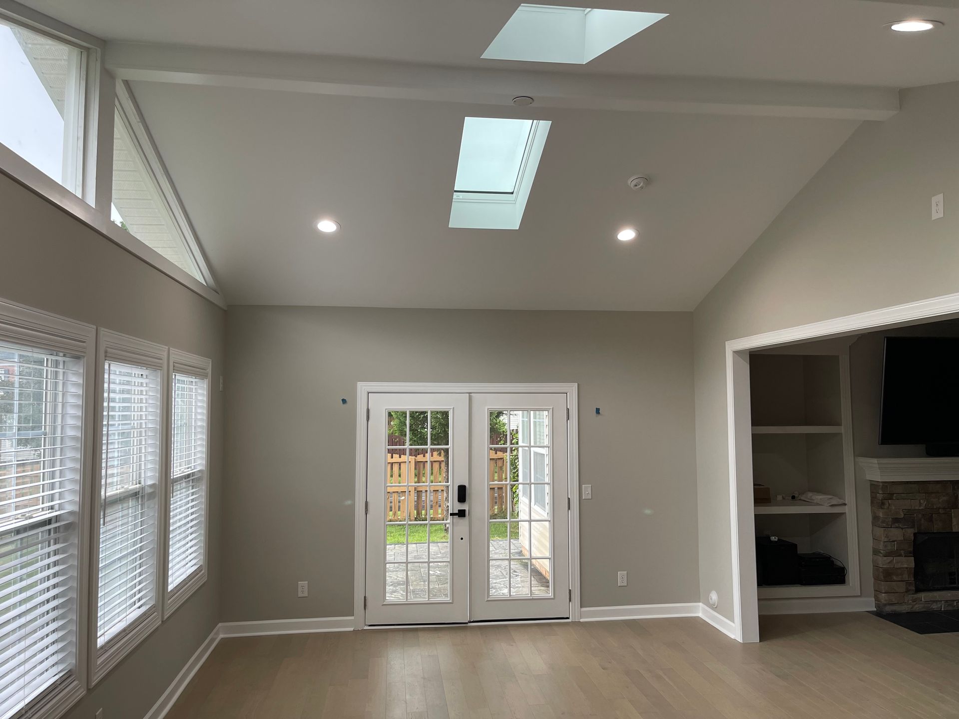 There is a skylight in the ceiling of the living room.