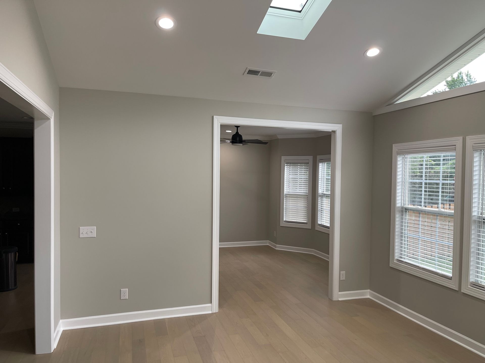 A room with a lot of windows and a skylight in the ceiling.