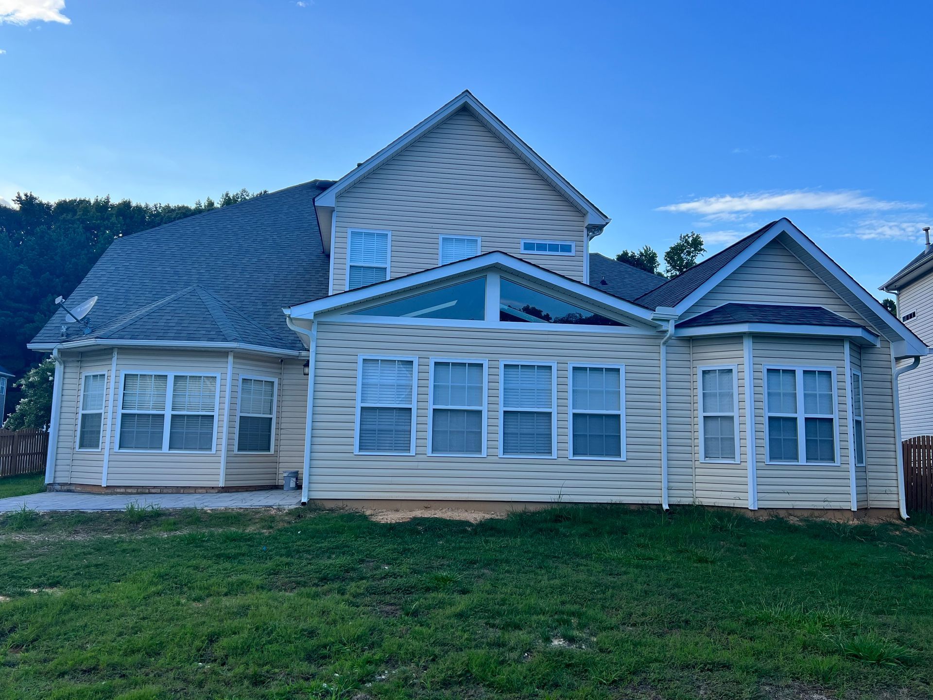 A large house with a lot of windows and a patio