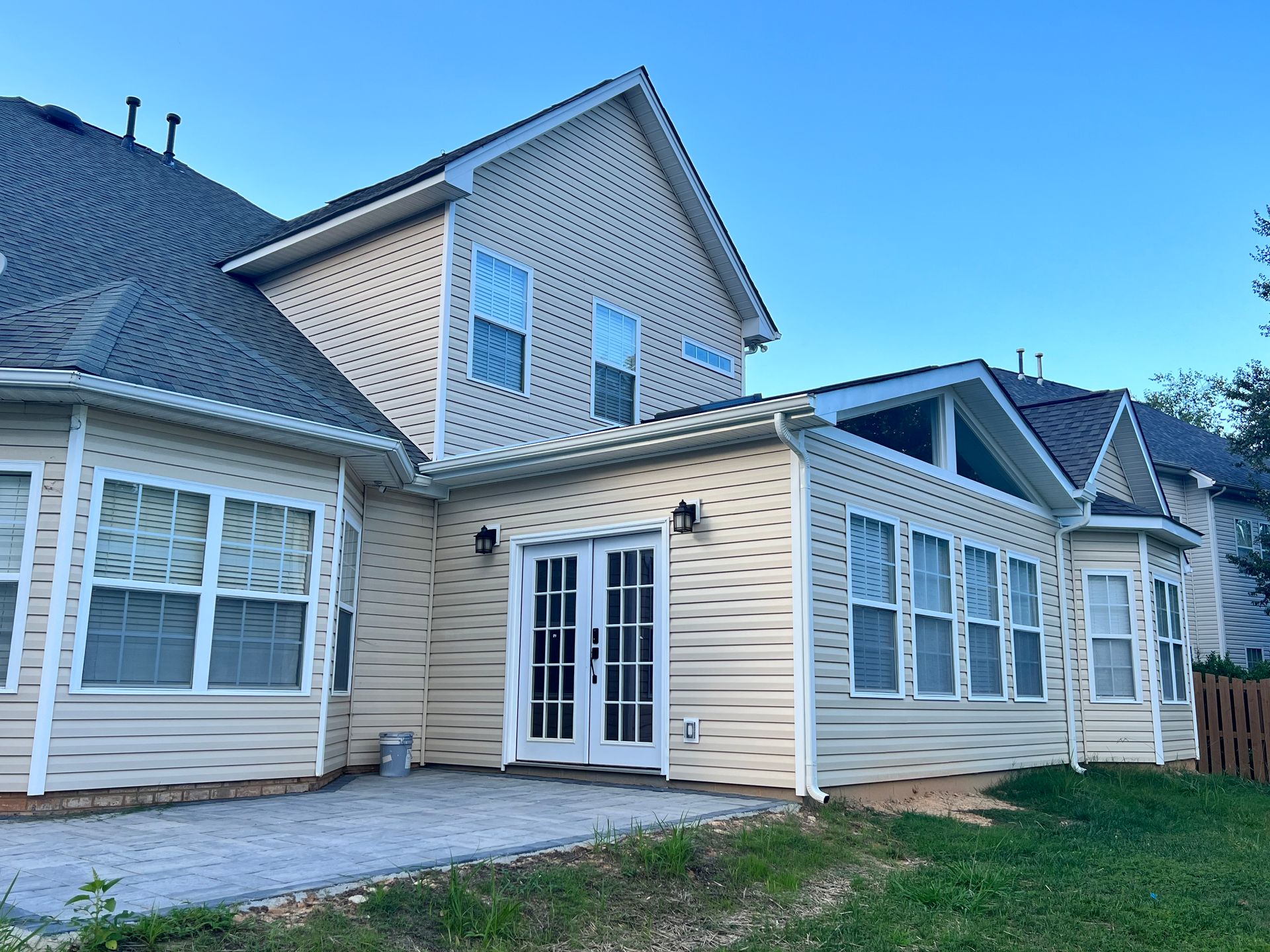 A large house with a lot of windows and a patio