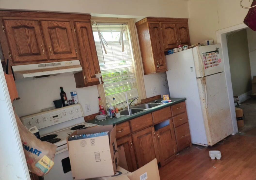 A kitchen with boxes and a bag that says walmart on it