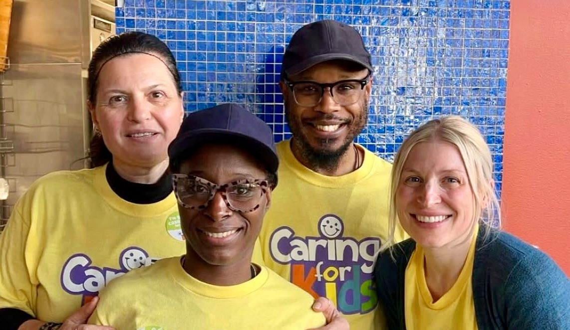 Four people wearing yellow 