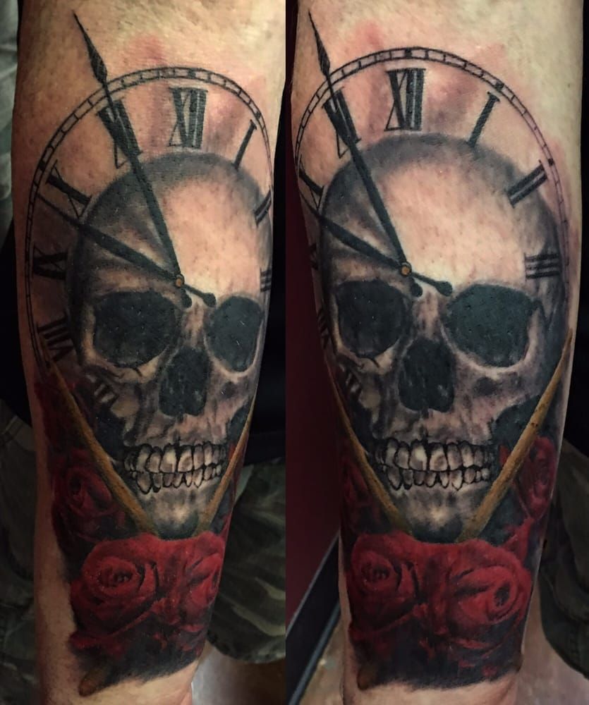 A tattoo of a skull and a clock with roman numerals