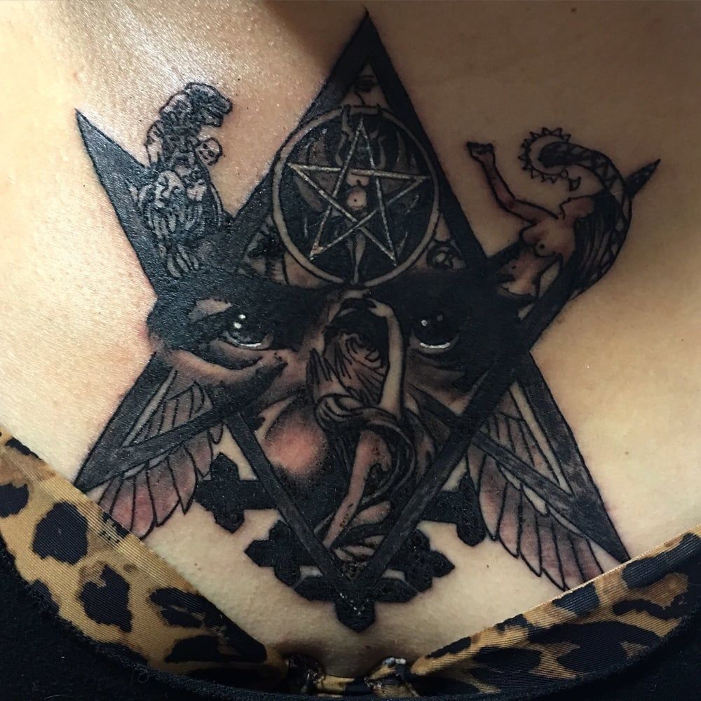 A woman has a pentagram tattoo on her chest