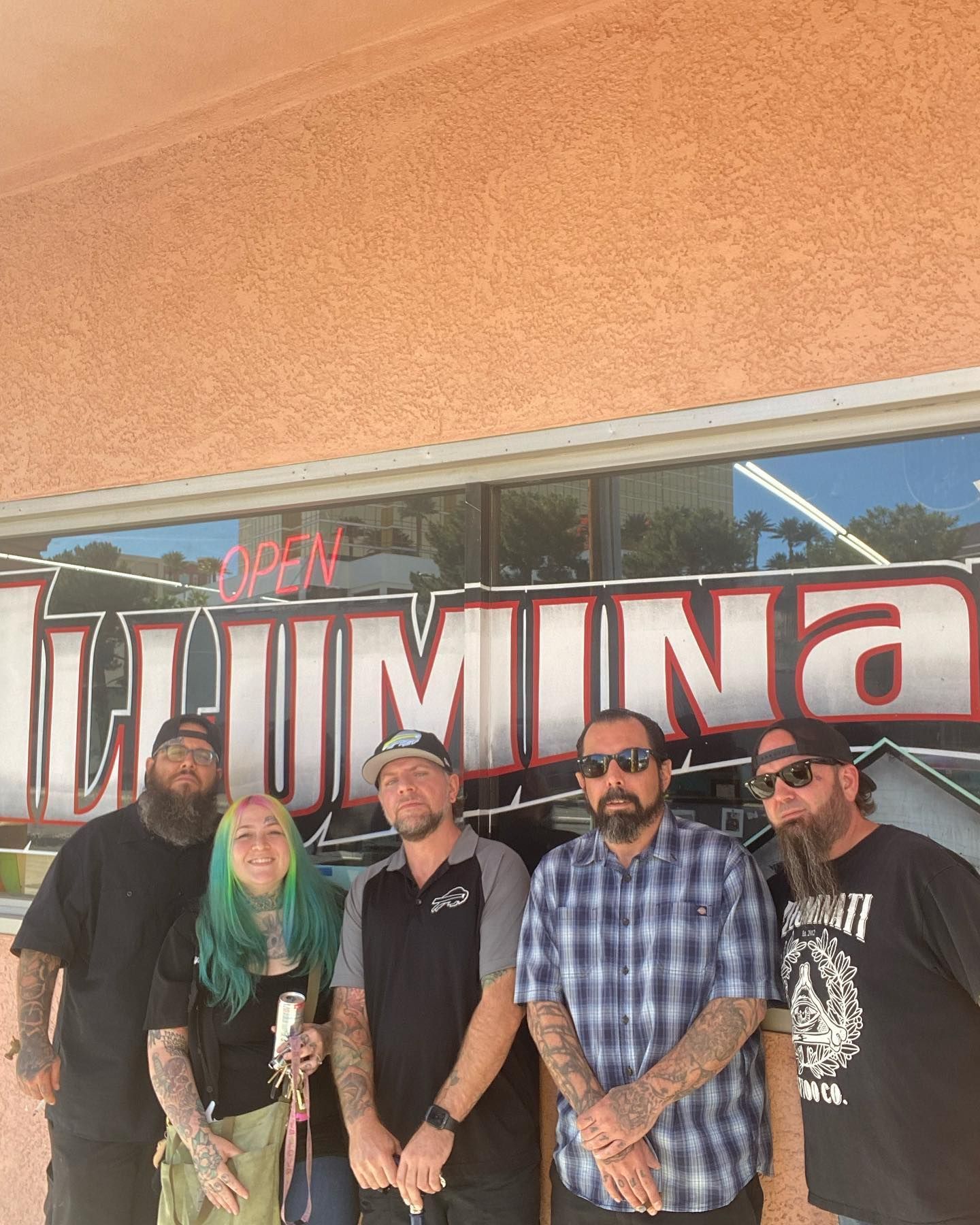 A group of people are standing in front of a store called lumina