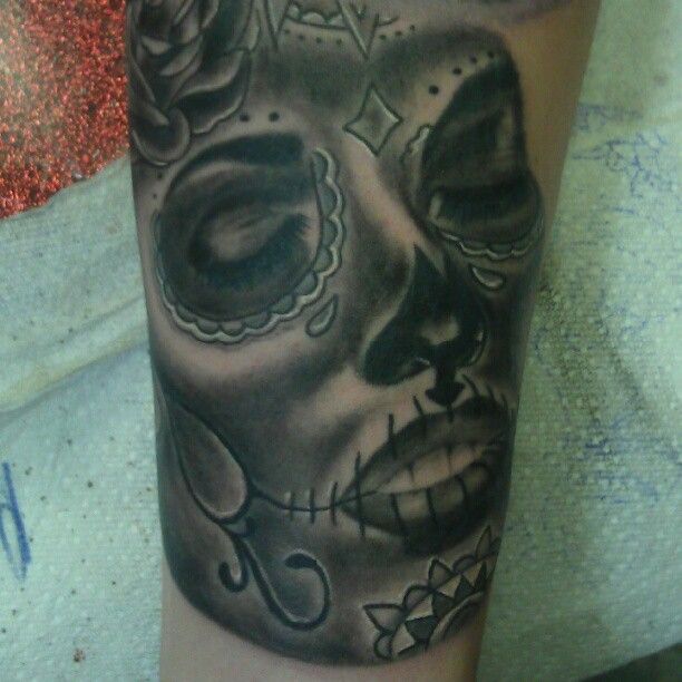 A black and white tattoo of a woman 's face