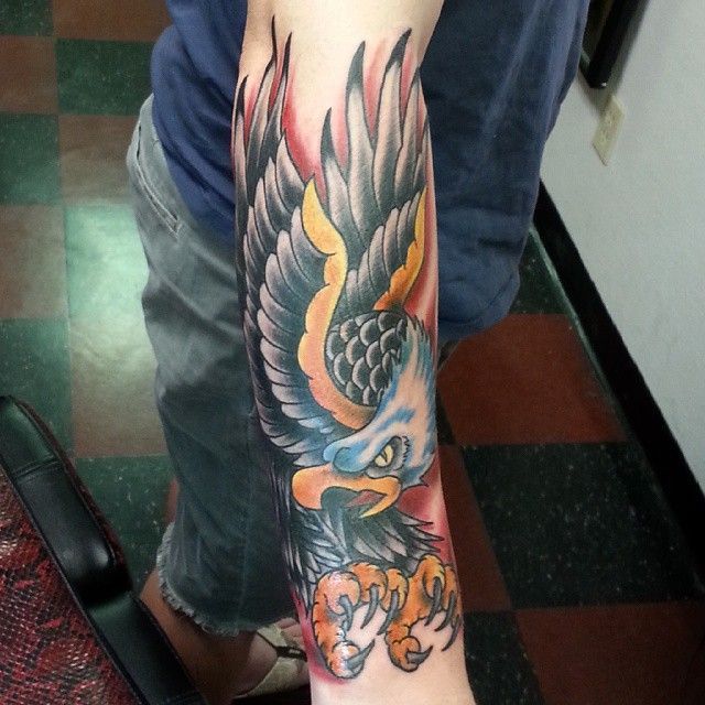 A man has a tattoo of an eagle on his arm