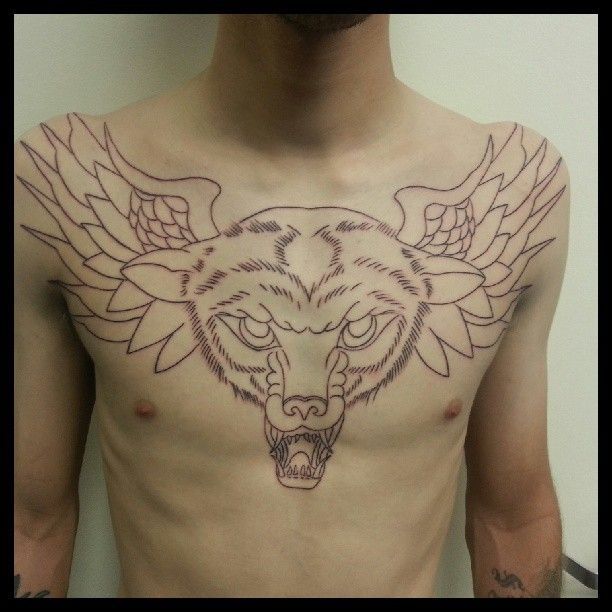 A man has a tattoo of a tiger on his chest
