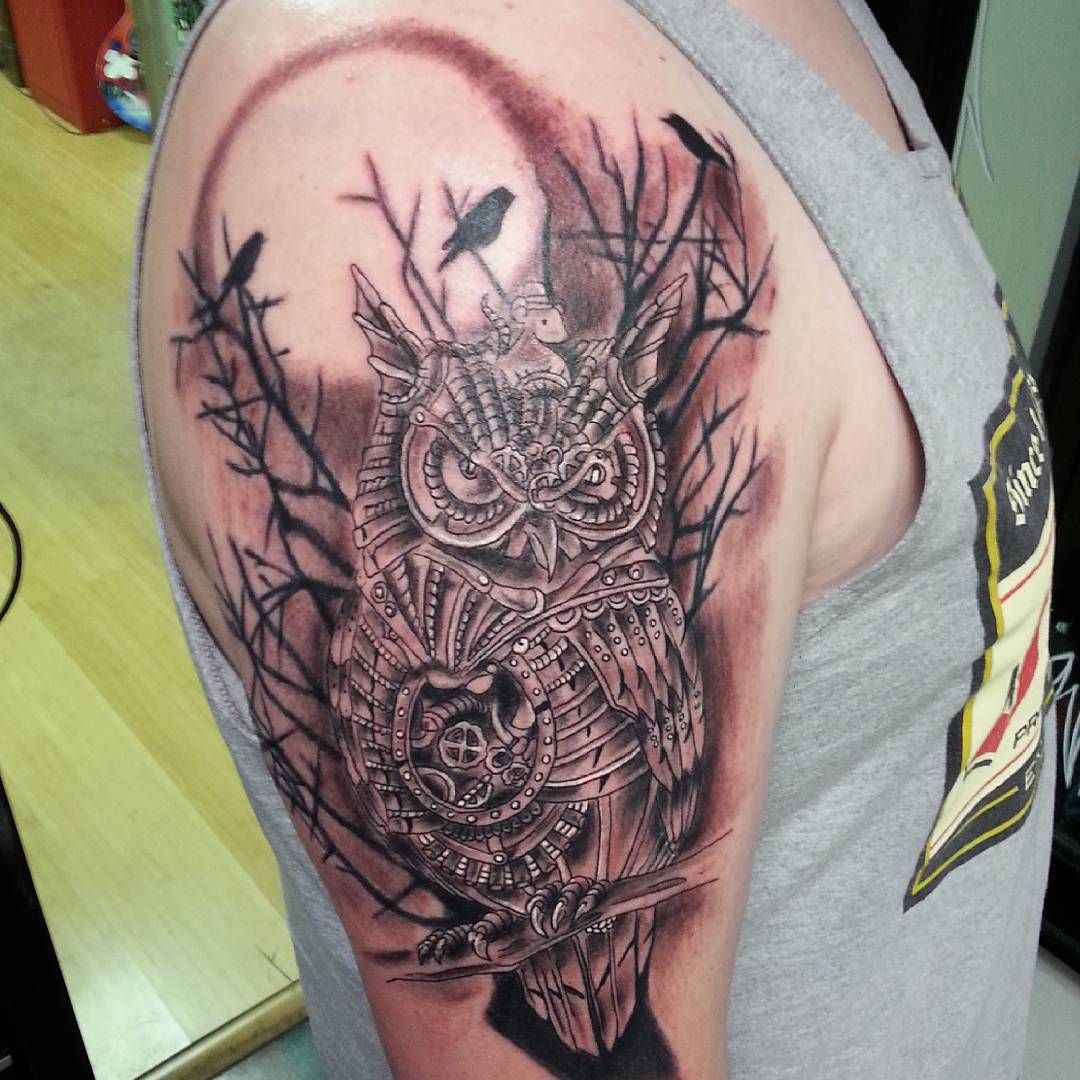 A man has a tattoo of an owl on his arm