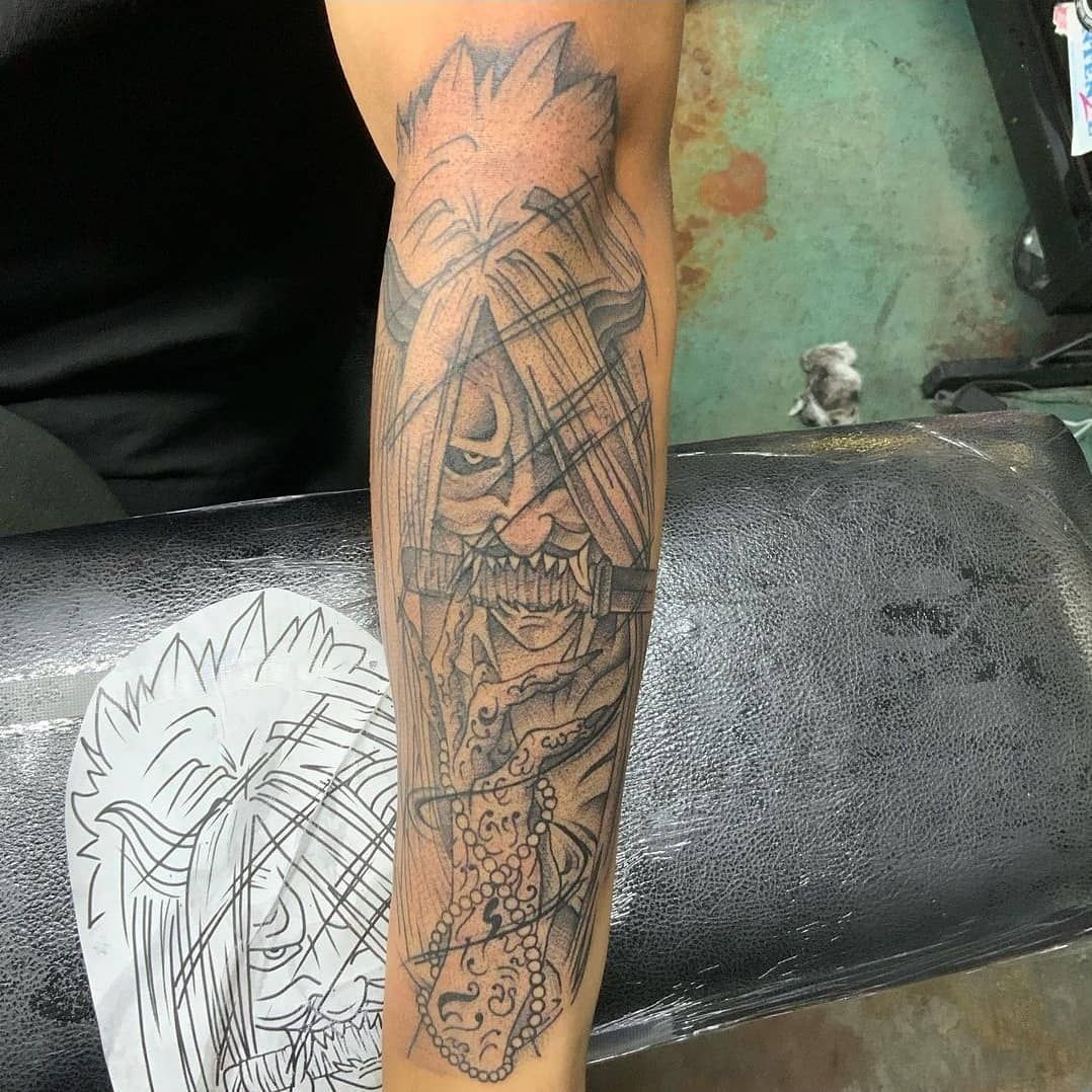 A person is getting a tattoo on their arm.