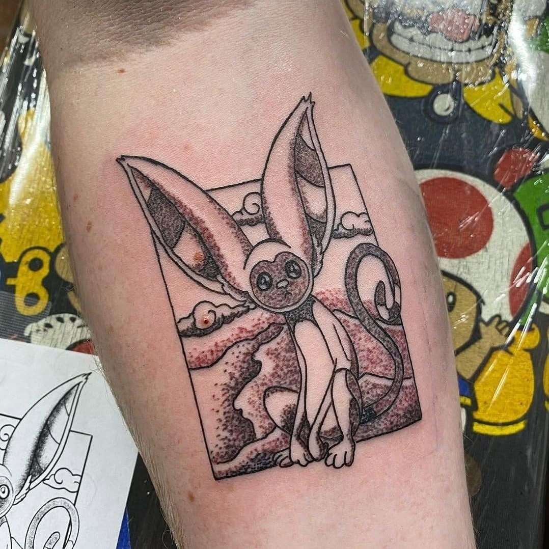 A person has a tattoo of a rabbit on their forearm.