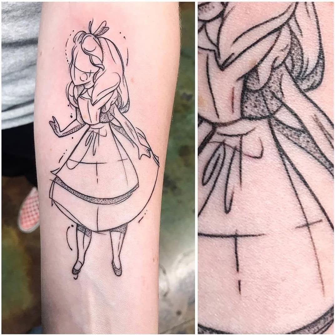 A tattoo of alice from alice in wonderland on a person 's forearm.