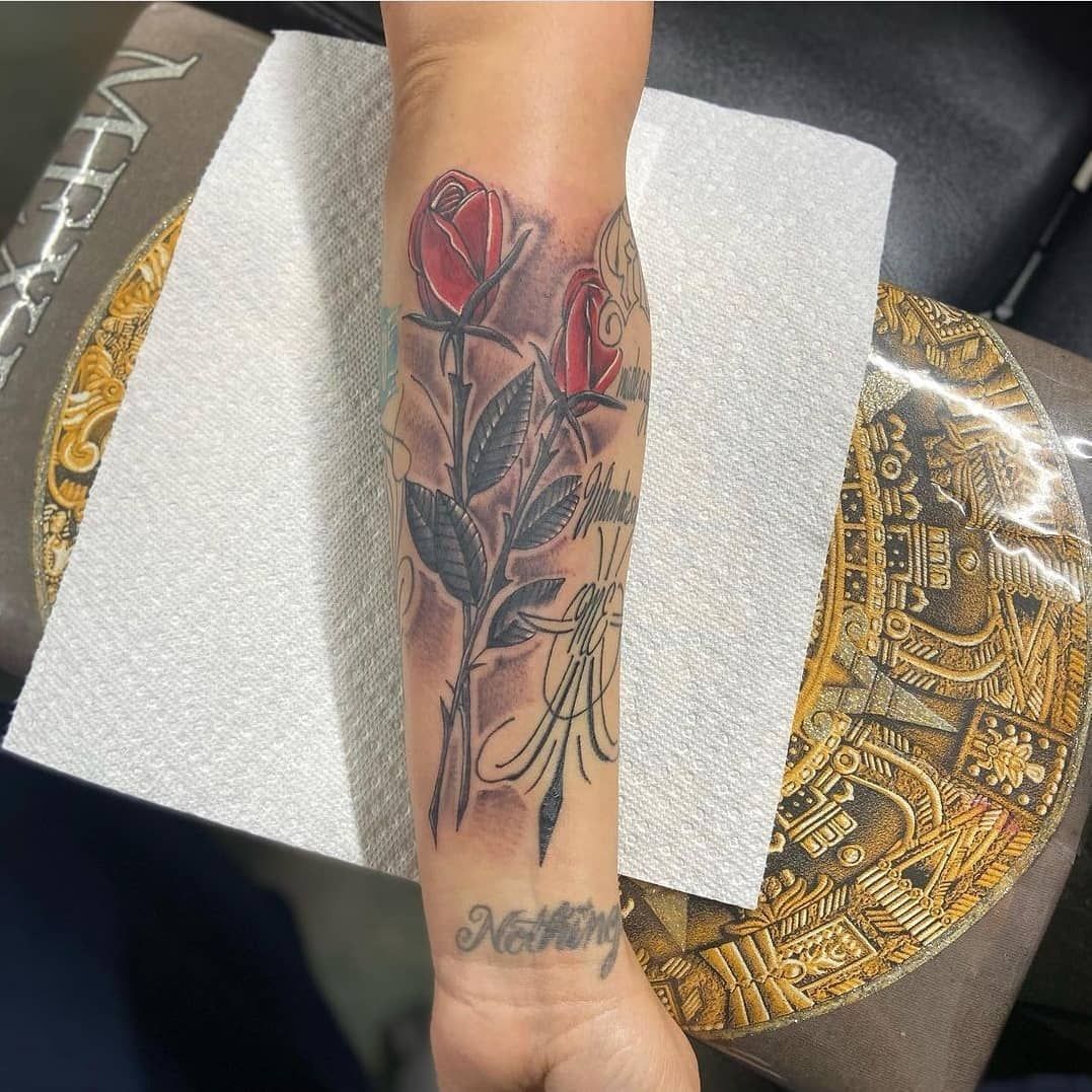 A person has a tattoo on their arm that says nothing