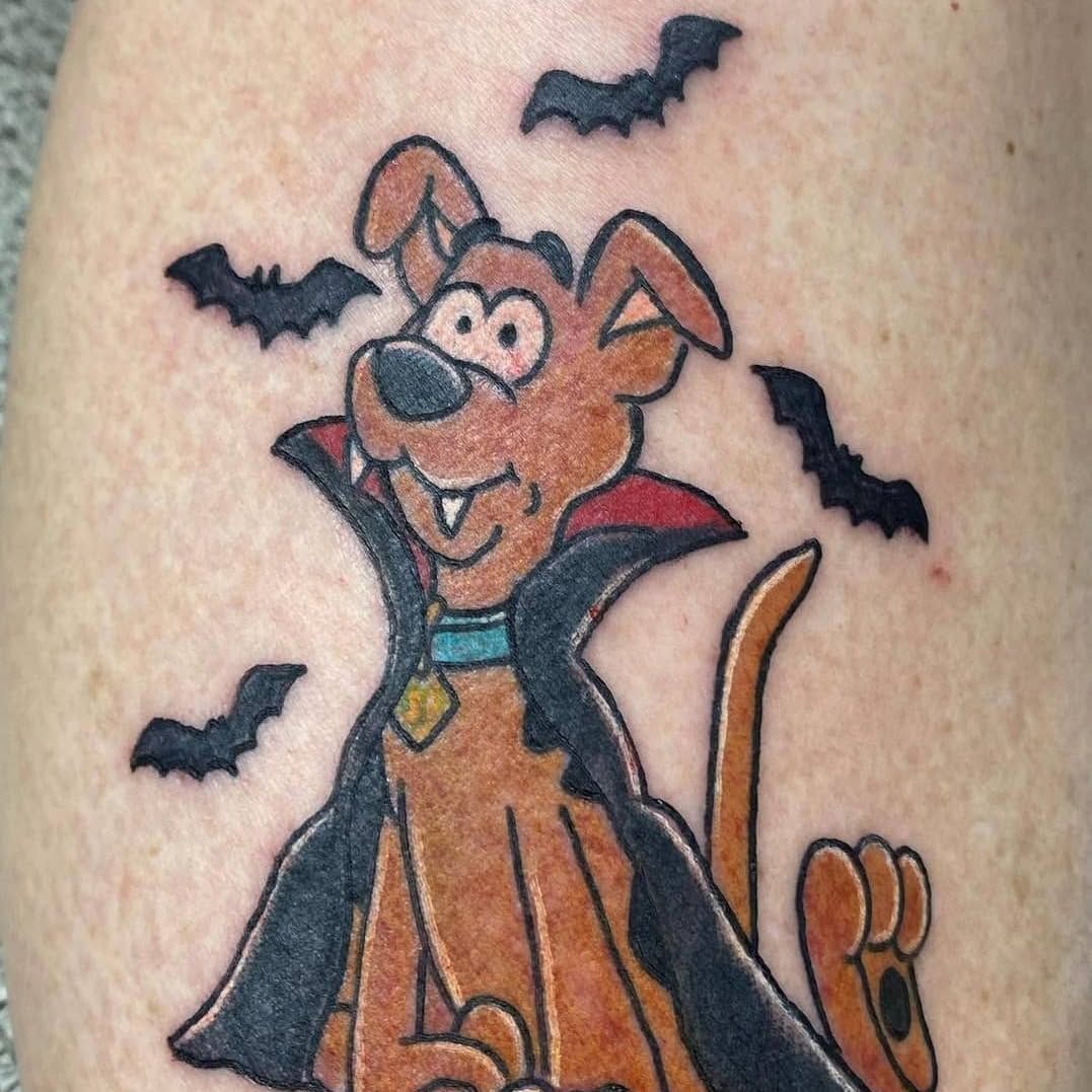 A tattoo of scooby doo dressed as a vampire
