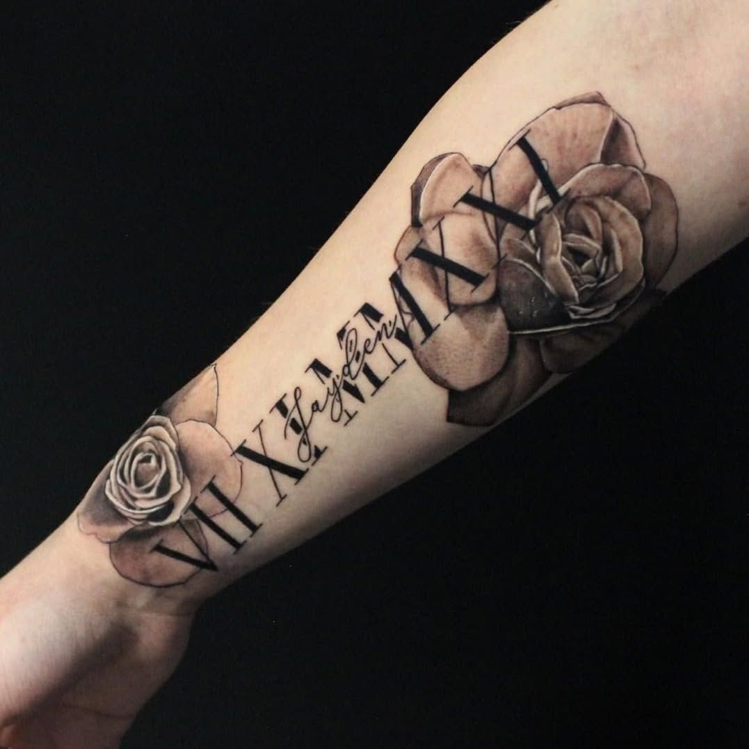 A person has a tattoo of roman numerals and roses on their forearm