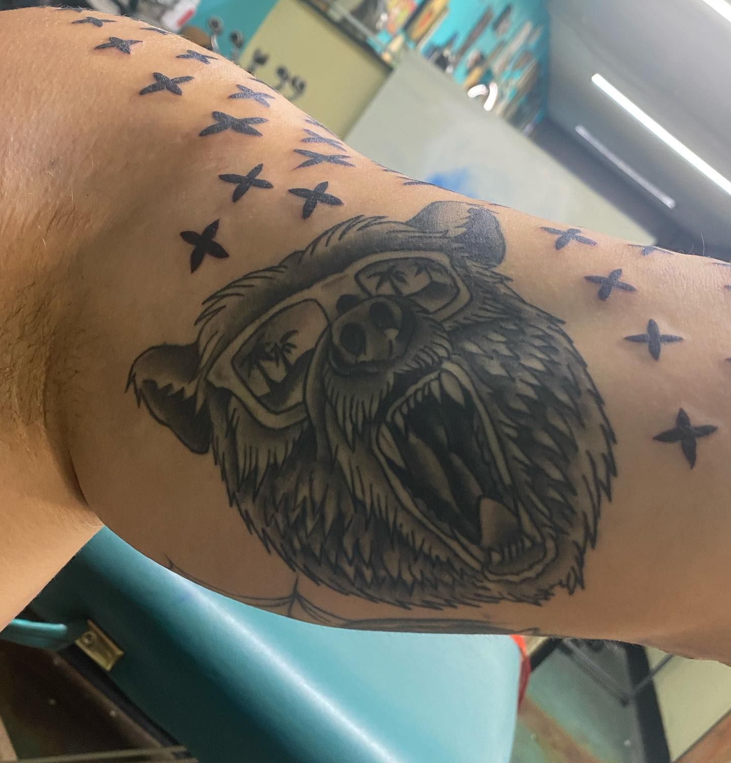 A man has a tattoo of a bear on his arm