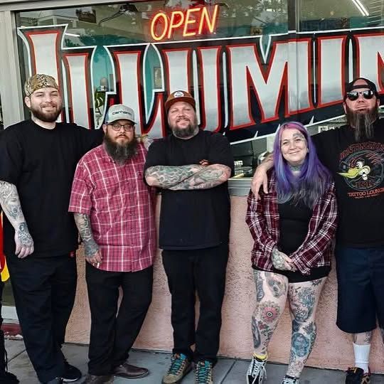 A group of people standing in front of a sign that says open