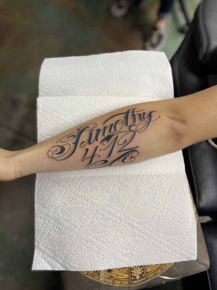 A person is getting a tattoo on their forearm.